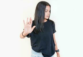 Young girl gesturing stop with palm of hand isolated. Teenage girl rejecting with the palm of her hand. Latin people gesturing stop isolated photo