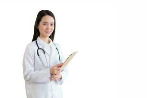 Professional beautiful young Asian woman doctor working at hospital. She wear white robe and stethoscope and hold clipboard in her hands while isolated on white background. photo