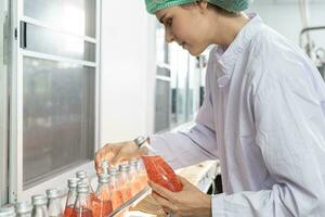 quality inspector food or beverages technician inspection about quality control food or beverages before send product to the customer. Production leader recheck ingredient and productivity. photo