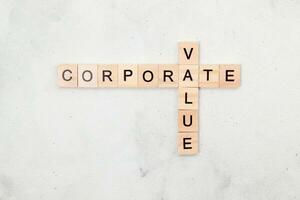 Top view of Corporate Value word on wooden cube letter block on white background. Business concept photo