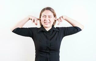 Displeased young woman covering her ears isolated. Latin girl covering her ears tightly isolated photo