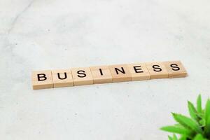 Top view of Business word on wooden cube letter block on white background. Business concept photo