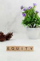 Top view of Equity word on wooden cube letter block on white background. Business concept photo