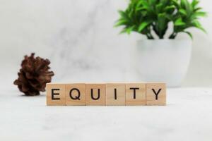 Top view of Equity word on wooden cube letter block on white background. Business concept photo