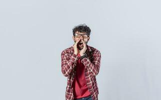 Handsome man in glasses shouting an announcement, isolated. A person announcing and yelling, concept of a guy yelling an announcement photo