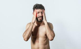 Shirtless man with headache, person with headache on isolated background, man in pain holding his head, migraine man concept photo