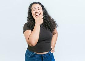 Happy young latin woman holding chin laughing isolated. Portrait of funny latin woman smiling isolated. Portrait of young woman nicaraguan photo