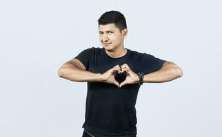 Man forming a heart with his fingers on isolated background, Person putting his hands together in the shape of a heart, happy man putting his hands together in the shape of a heart, photo