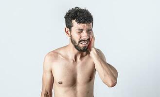 Person with earache on isolated background, man with earache on isolated background, ear disease concept photo