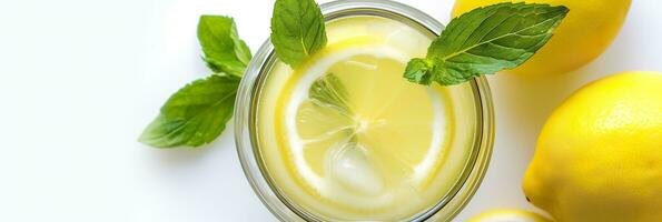 Lemonade in a glass with fresh lemons and mint. Cold summer drink with copy space. Generative AI photo