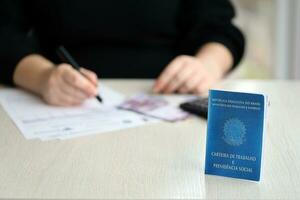 Brazilian work card and social security blue book lies on accountant or boss table photo