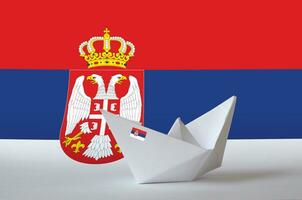 Serbia flag depicted on paper origami ship closeup. Handmade arts concept photo