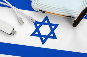 Israel flag depicted on table with internet rj45 cable, wireless usb wifi adapter and router. Internet connection concept photo