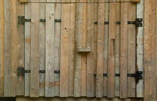 Old wooden door from farm barn made with handmade wood planks photo