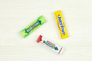 KHARKOV, UKRAINE - FEBRUARY 14, 2021 Wrigleys Spearmint Doublemint and Juicy Fruit chewing gum in classic design photo