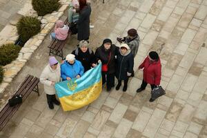 TERNOPIL, UKRAINE - APRIL 2, 2023 People with flag during mission in complex of Ukrainian Jerusalem in the Mari spiritual center of Zarvanytsia In the Terebovlya district of the Ternopil photo