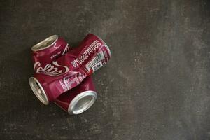 KYIV, UKRAINE - 4 MAY, 2023 Coca cola soft drink crumpled tin can with cherry flavour photo