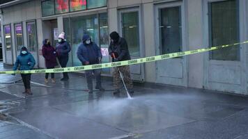 NEW YORK CITY, USA - JANUARY 23, 2021 Worker Washing Street in Manhattan. People Wearing Masks During Coronavirus Pandemic video