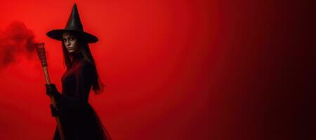 A mysterious witch clad in a floor-length red dress with black hat and broom, she exudes an aura of power and darkness. Red foggy background enhances the dramatic effect. Generative AI photo