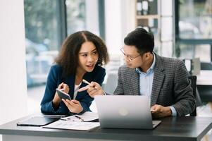 Business leading team meeting and using tablet and laptop with financial in office photo