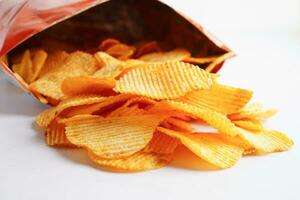 Potato chips in open bag, delicious BBQ seasoning spicy for crips, thin slice deep fried snack fast food. photo