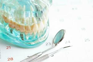 Dental appointment reminder in calendar, healthy teeth, dental health care. photo