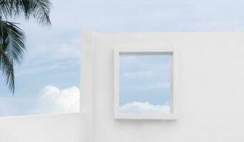 Architecture minimal exterior white wall cement surface texture,Concrete house with open window against blue sky and clouds, Modern building geometry with summer sky and coconut palm leaves photo