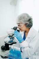 Scientist team meeting and writing analysis results in the laboratory study and analyze scientific sample photo