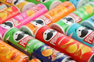 KYIV, UKRAINE - 4 MAY, 2023 Many pringles tubes of chips with various flavours photo