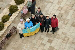 TERNOPIL, UKRAINE - APRIL 2, 2023 People with flag during mission in complex of Ukrainian Jerusalem in the Mari spiritual center of Zarvanytsia In the Terebovlya district of the Ternopil photo