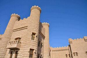 the castle is made of stone and has two towers photo