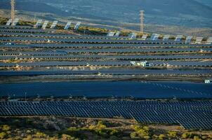 solar panels are seen in the desert near a mountain photo