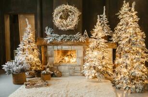 The interior of a room with a fireplace, Christmas trees with artificial snow and garlands, a blanket and a tray with hot drinks. The magical atmosphere of Christmas. photo