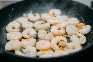 Preparing Sarsuella in a cooking mater class. Shrimp close-up. home-cooked food. prawns in a pan photo