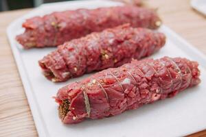 Cooking meat rolls in a cooking class. The beef roll. Raw meat, close-up. photo