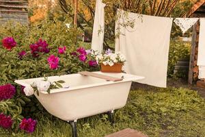 A place for washing and drying clothes, sheets and clothes on the street in the courtyard of a village house. Bathroom in the street courtyard. The concept of autumn photo