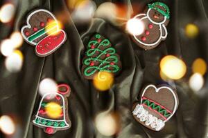 Banner for Christmas and New Year gingerbread. Christmas trees, toys, snowmen, garlands on a background of brown silk fabric. Bright bokeh. photo