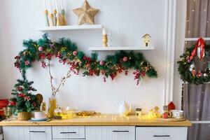 Kitchen interior decorated for Christmas and New Year. New Year's interior in red and white tones. photo