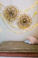 The interior of a children's room decorated for the Christmas holidays. Soft mattresses with garlands in the form of stars. photo