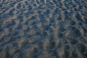 a close up of sand with ripples photo