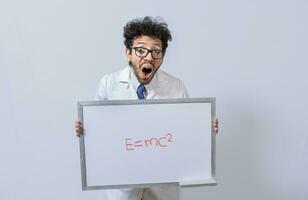 Scientist holds and points to a whiteboard with a mathematical formula. Scientist showing blackboard with mathematical equation, Physics professor holding whiteboard with a mathematical formula photo