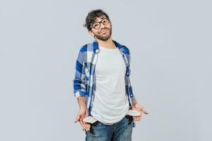 Sad man with no money showing his empty pockets, Unemployed people showing their empty pockets. Frustrated unemployed young man showing his empty pockets. Unemployed people concept photo