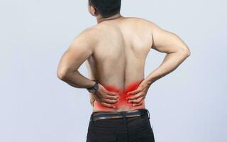 Person with back problems on isolated background, lumbar problems concept, A man with spine problems, a sore person with back pain photo