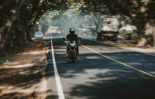 Motorcycle driver at full speed on the highway. Motorcyclist driving at high speed on the street photo