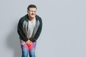Person with urinary problems, Medical problem urinary incontinence. people with crotch pain, Man with hands on crotch with urinary problems photo
