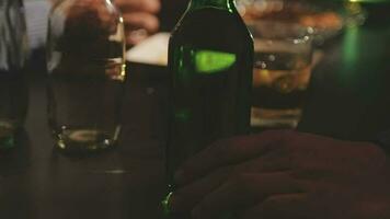 food and drink male friends are happy drinking beer and clinking glasses at a bar or pub. video