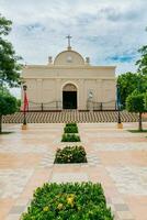 Nagarote Park Catholic Church. Nicaragua, View of a church in a beautiful central park on a sunny day. Beautiful church in a park with a garden and trees photo