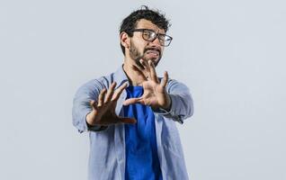 a man with rejection expression, man with scared expression on his face making frightened gesture with his palms, scared man asking you to stop photo