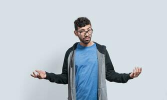 Puzzled person spreading hands, Clueless person with open arms, Man with a face of not having an answer photo