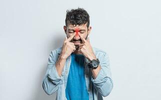 People with pain touching nose. Handsome man with nasal bridge pain, Man with nasal bridge headache. Sinus pain concept photo